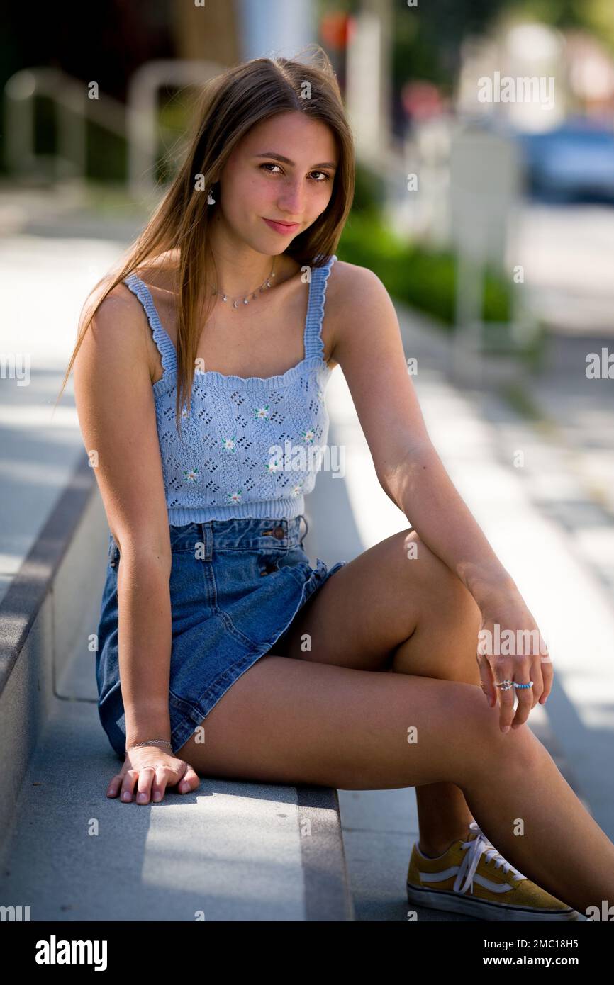 Teenage Girl Sitting on Steps in Front of City Hall Plaza in Downtown Palo Alto Stock Photo