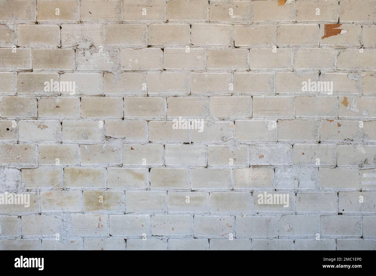 Old brick wall white wash plaster grunge background Stock Photo