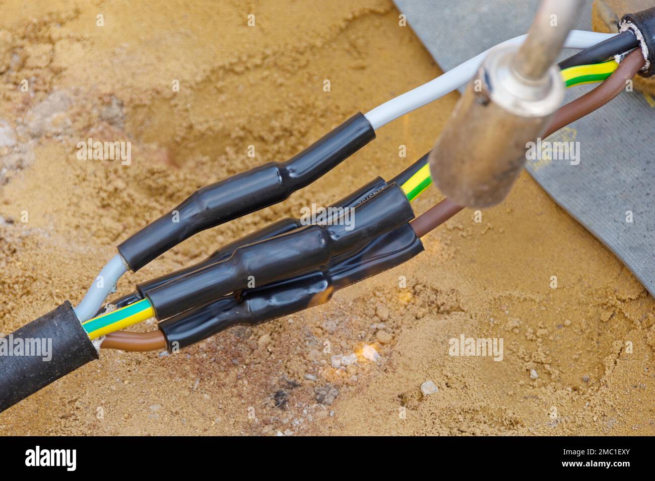 Connected power cables for house connection in the ground with shrink tubes Stock Photo