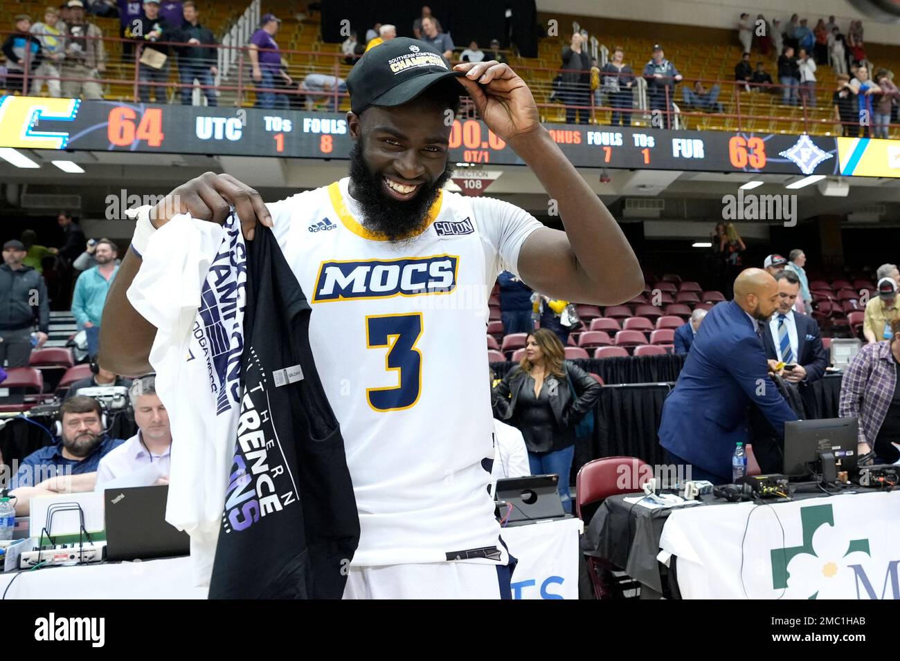 Chattanooga guard David JeanBaptiste (3) puts on his championship cap