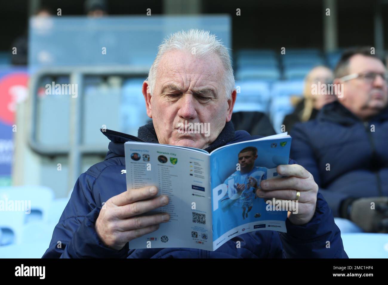 A Coventry City fan reads a program prior to the Sky Bet Championship match at the Coventry Building Society Arena, Coventry. Picture date: Saturday January 21, 2023. Stock Photo