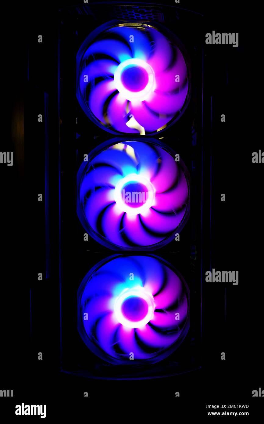 Computer cooler with RGB LED light. Computer circuit board and CPU cooling fans illuminated Stock Photo