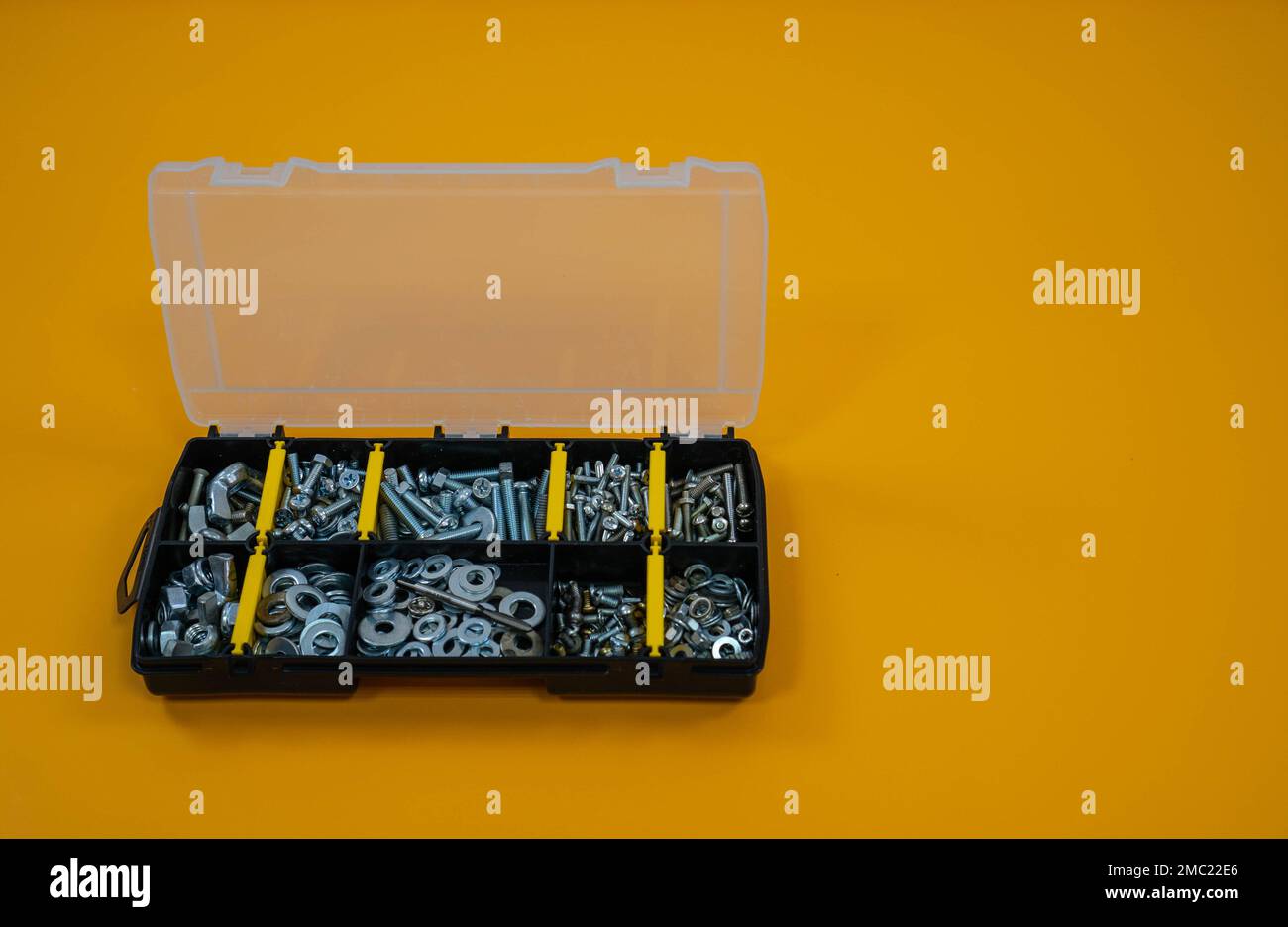 Yellow storage case with screws, nuts, bolts, nails and other small tools  for handyman, close up 12799187 Stock Photo at Vecteezy