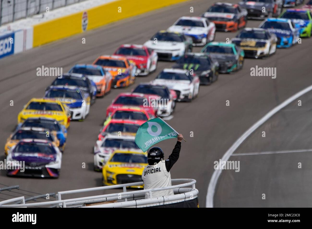 An official restarts the race after a caution flag during a NASCAR Cup