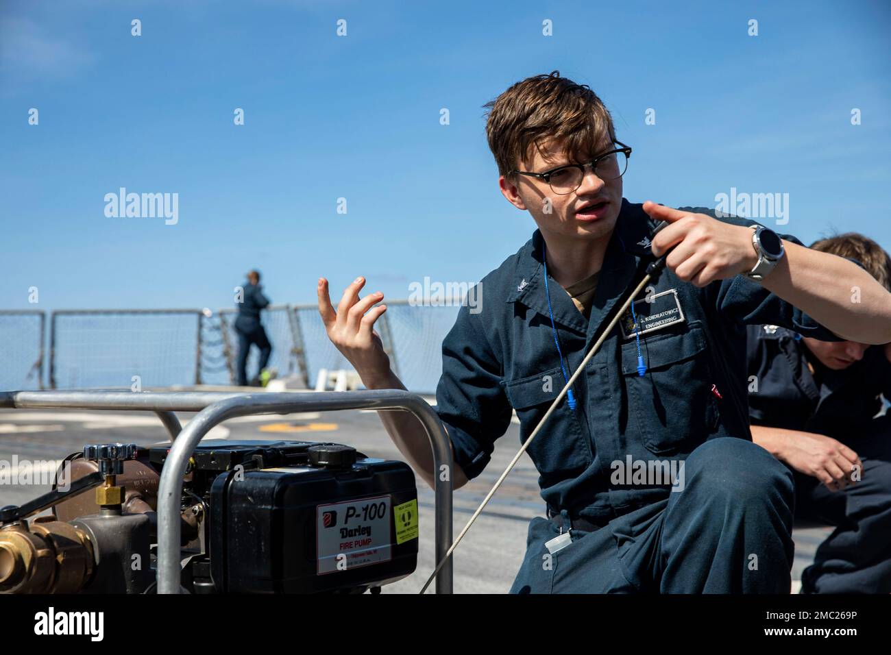 220623-N-UL352-1008 ATLANTIC OCEAN (June 23, 2022) Damage Controlman 3rd Class Garrett Kondratowicz, assigned to Arleigh Burke-class guided-missile destroyer USS Delbert D. Black (DDG 119), trains Sailors on the use of a portable suction pump, June 23, 2022. The George H.W. Bush Carrier Strike Group (CSG) is underway completing a certification exercise to increase U.S. and allied interoperability and warfighting capability before a future deployment. The George H.W. Bush CSG is an integrated combat weapons system that delivers superior combat capability to deter, and if necessary, defeat Ameri Stock Photo