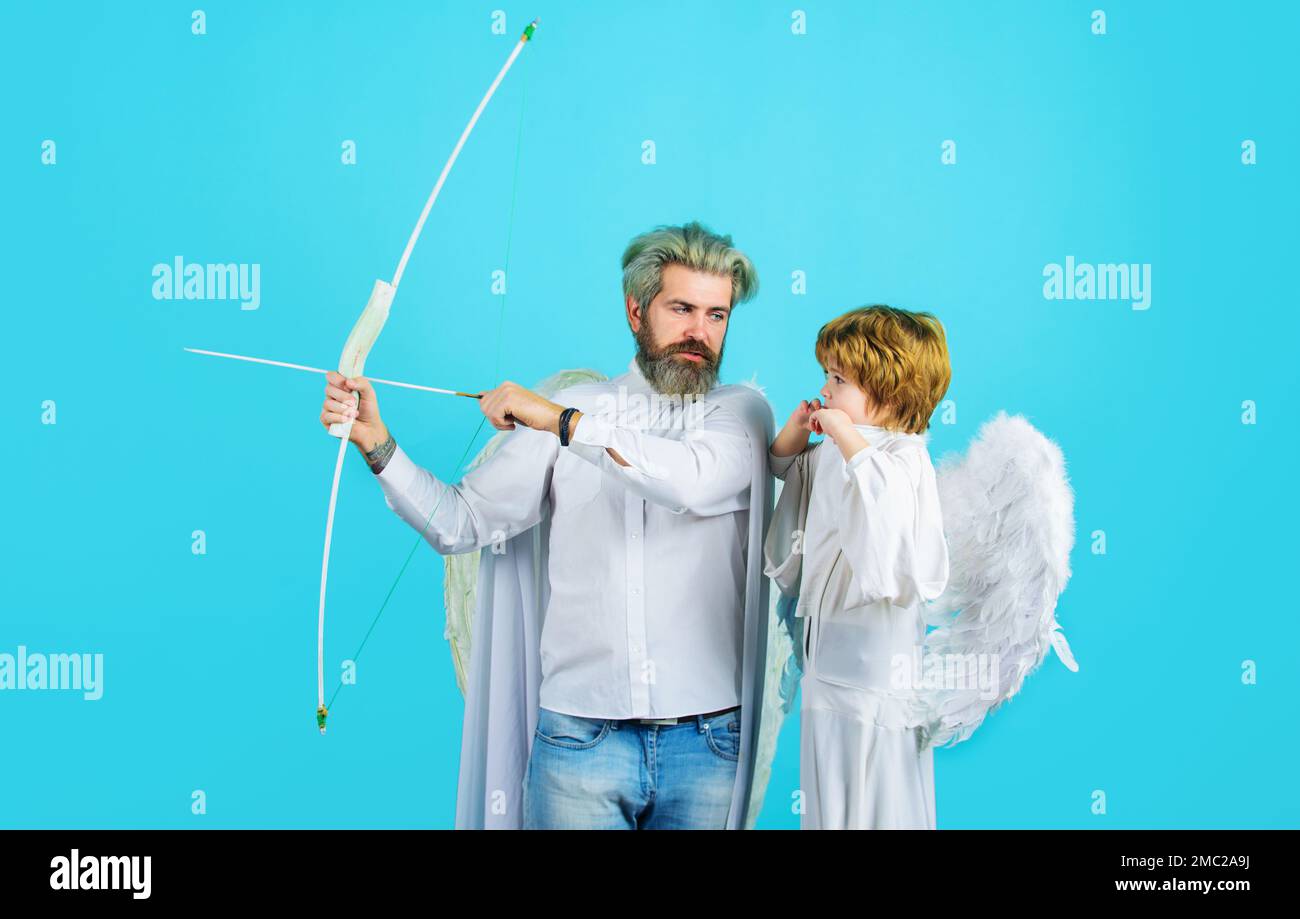 Valentines angels. Little cupid boy and father in angelic wings with bow and arrow. Arrows of love. Stock Photo