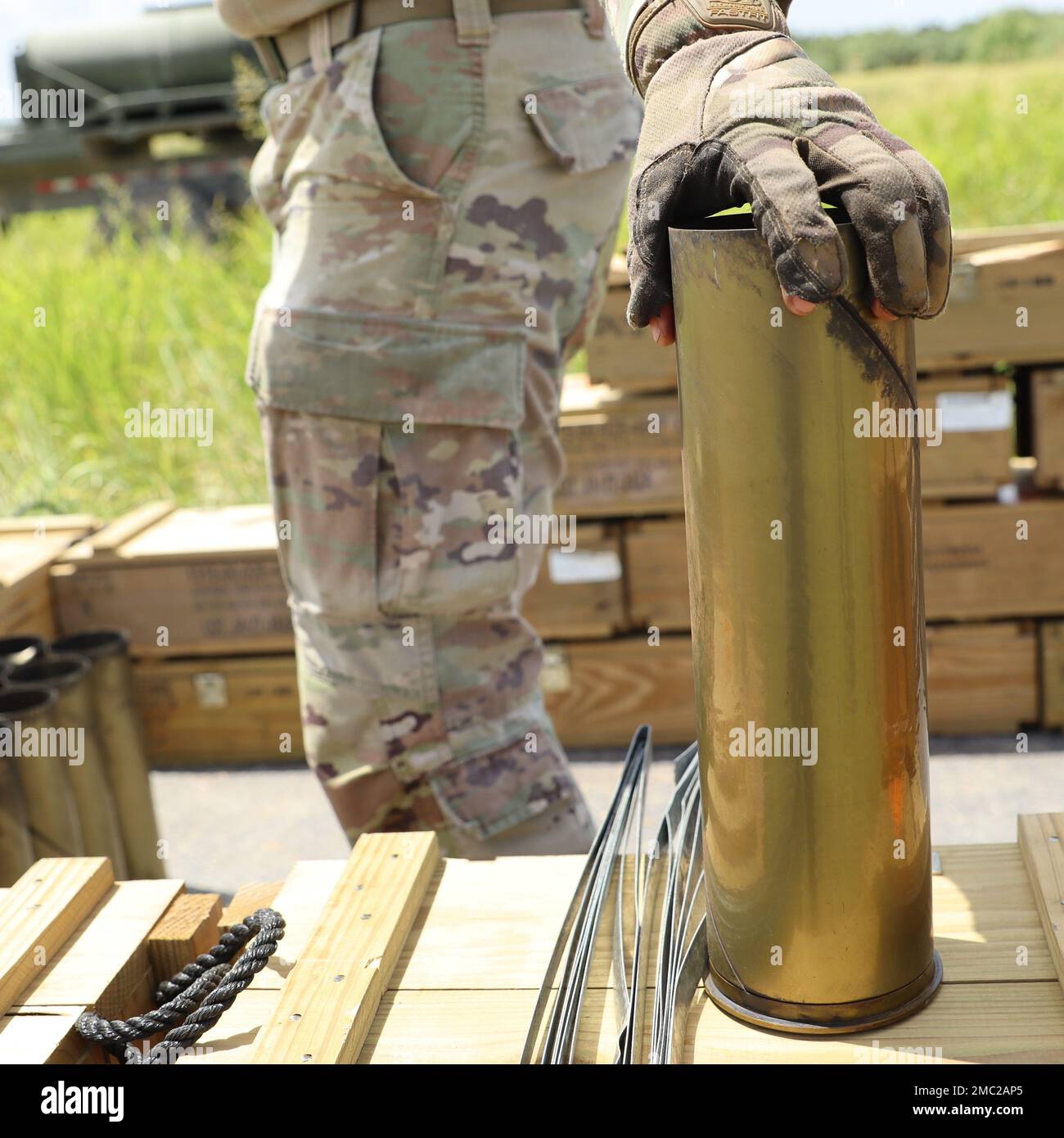 22 FAR soldier consolidating and organizing artillery fire dunnage during a live fire exercise