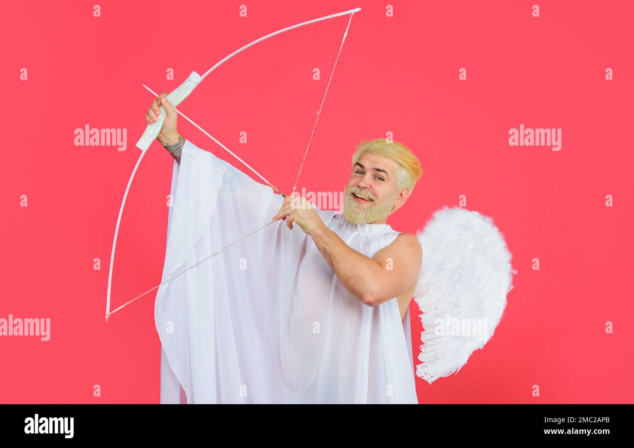 Valentines Day. Male angel with bow and arrows. Cupid in angelic wings shooting arrows of love. Stock Photo