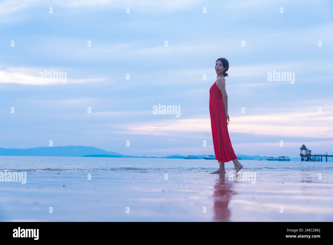 Happy young woman on the beach Stock Photo - Alamy