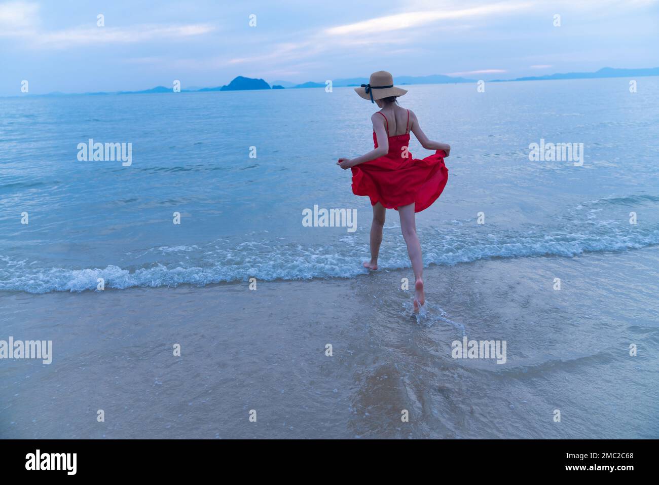 Happy young woman on the beach Stock Photo - Alamy