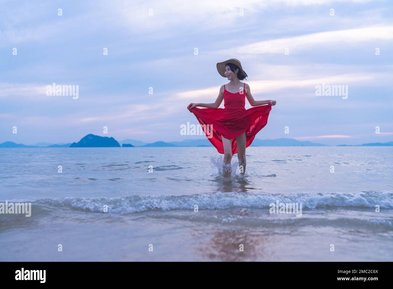 Happy young woman on the beach Stock Photo - Alamy