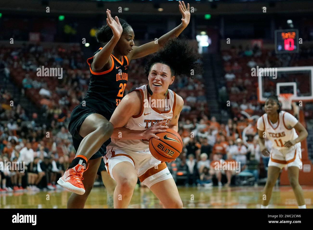 Texas guard Audrey Warren, right is pressured by Oklahoma State forward ...