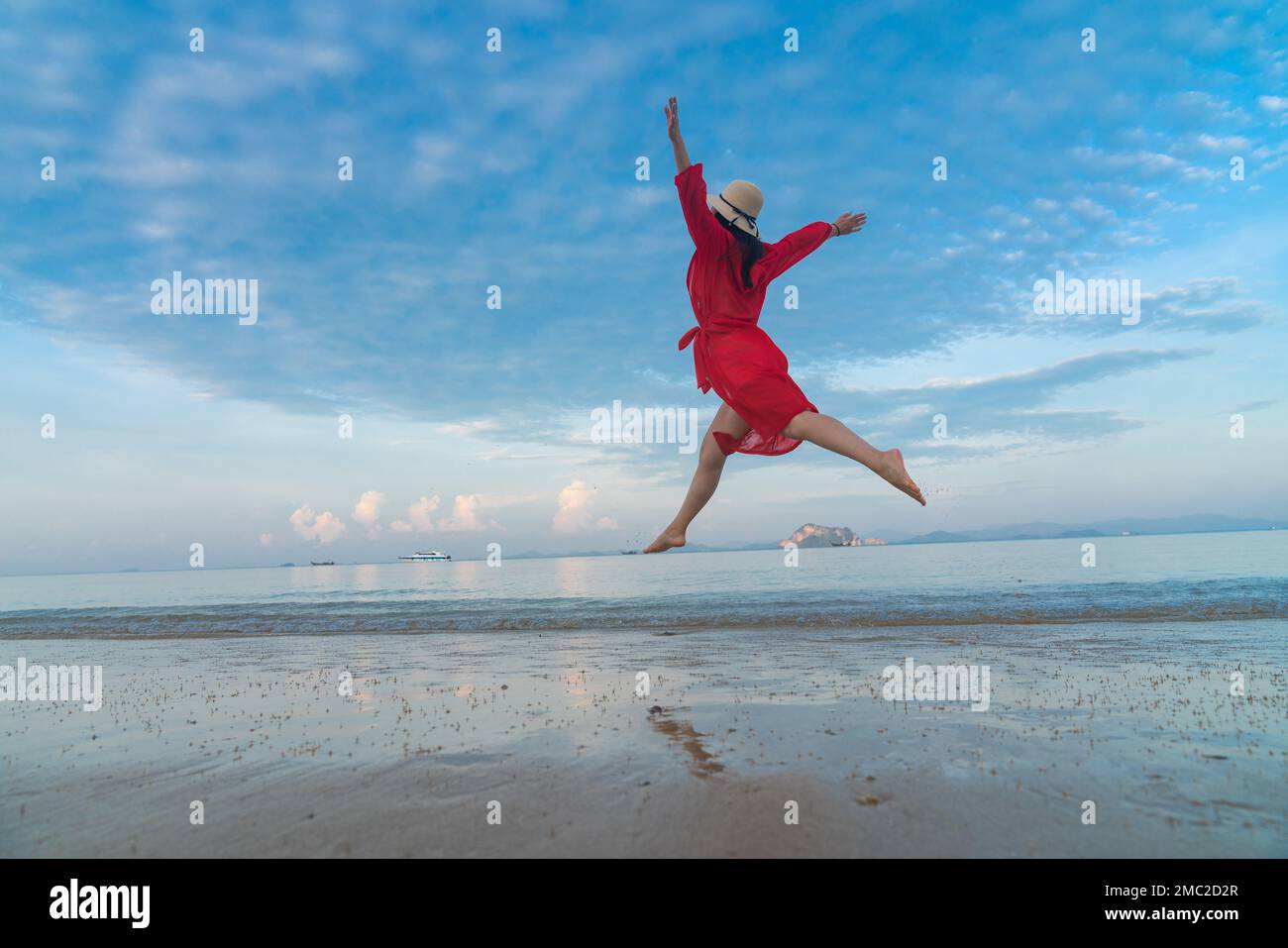 Happy young woman on the beach Stock Photo - Alamy