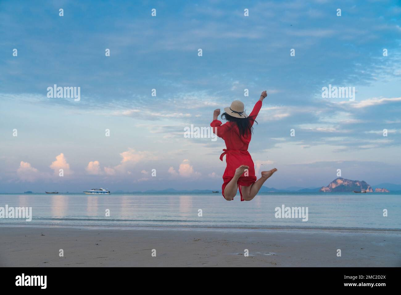 Happy young woman on the beach Stock Photo - Alamy
