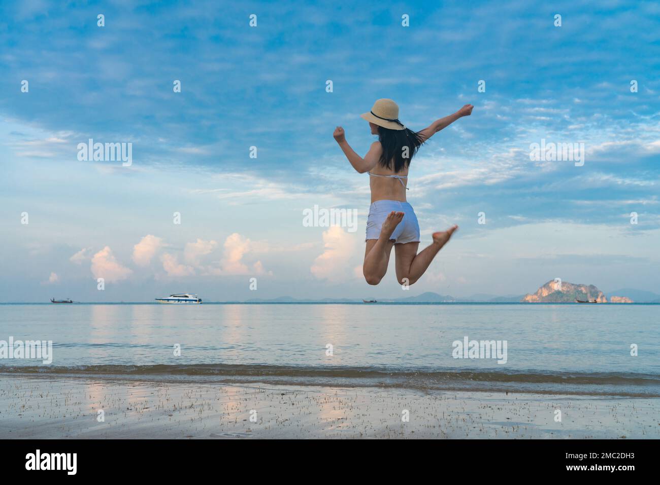 Happy young woman on the beach Stock Photo - Alamy