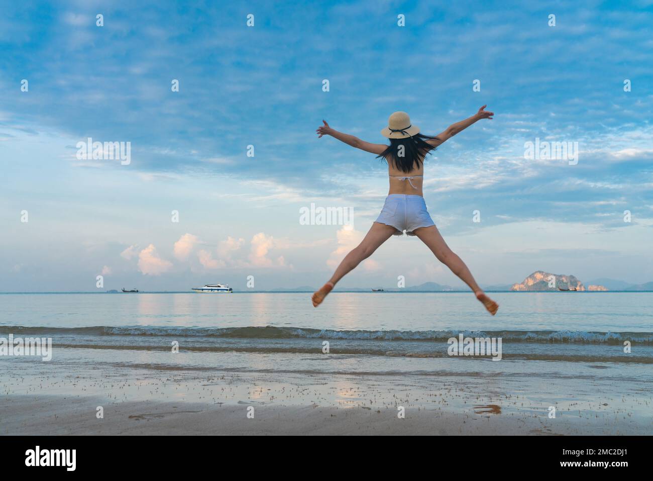 Happy young woman on the beach Stock Photo - Alamy