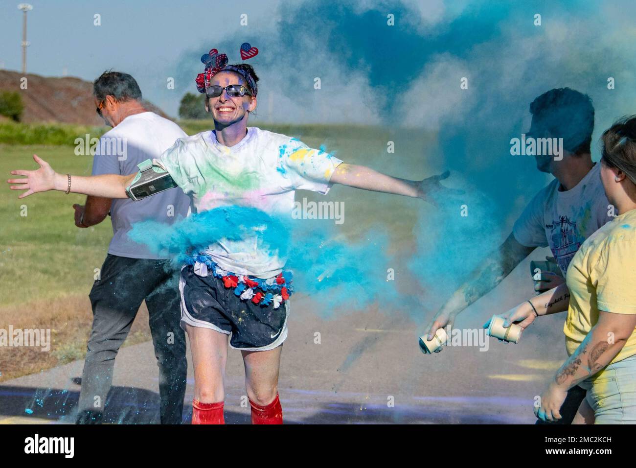 A participant runs through the finish line during the Pride Month color run at Altus Air Force Base, Oklahoma, June 24, 2022. Pride celebrations are credited to Brenda Howard, a bisexual New York activist nicknamed the “Mother of Pride,” who organized the first Pride parade to commemorate the one-year anniversary of the Stonewall Uprising. Stock Photo