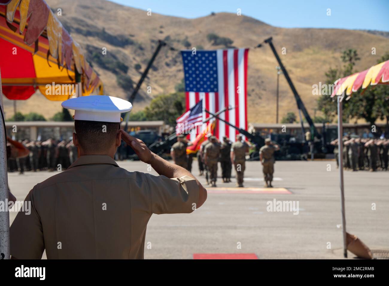 U.S. Marines with 1st Battalion, 11th Marine Regiment (1/11), 1st Marine Division, salute the flag for the national anthem during a change of command ceremony at Marine Corps Base Camp Pendleton, California, June 24, 2022. During the ceremony, Lt. Col. Matthew T. Ritchie relinquished command of 1/11 to Lt. Col. David J. Palka. Stock Photo