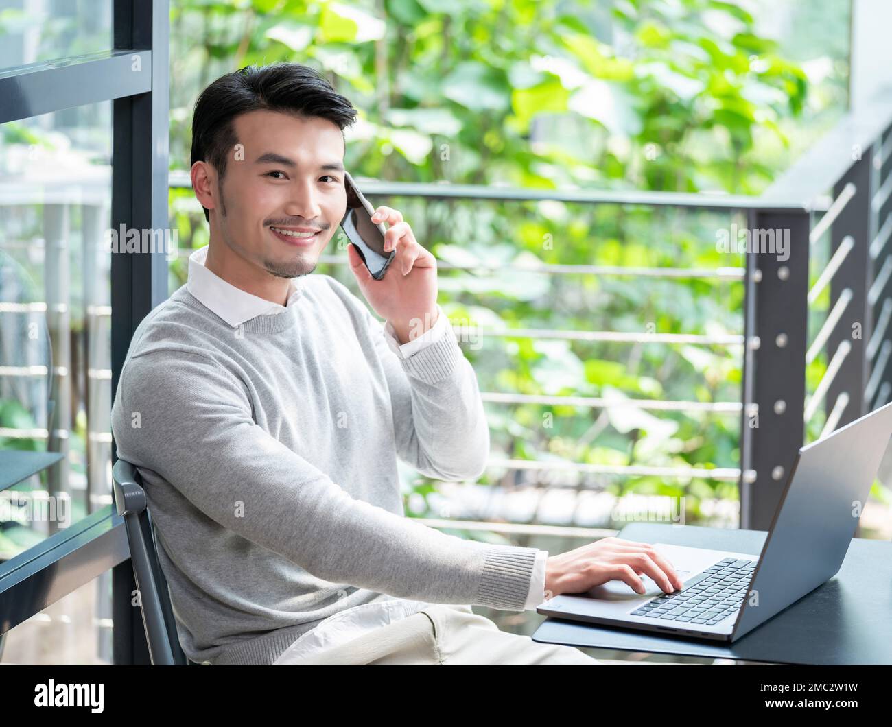 Young men who use a computer Stock Photo - Alamy