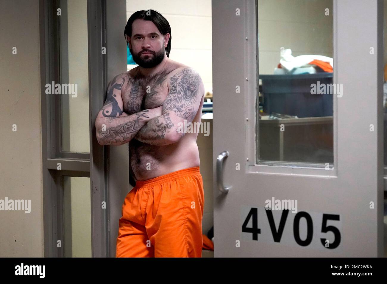 Erik Eck, a former member of the Latin Kings gang stands in the doorway of  his cell at the DuPage County, Ill., Jail displaying tattoos that symbolize  his status with the gang,, image size:1300x956