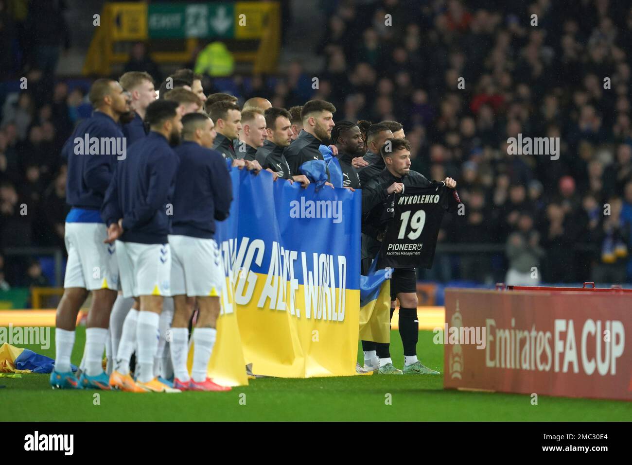Boreham Wood and Everton players stand on the pitch with a pro-peace  message i the colors of the Ukrainian flag before the English FA Cup 5th  round soccer match between Everton and