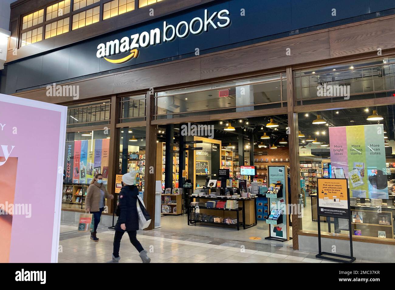 FILE - People walk by an Amazon Books store at the Westfield Garden State  Plaza shopping mall in Paramus, N.J., Monday, Jan. 10, 2022. Amazon  confirmed on Wednesday, March 2, 2022, that