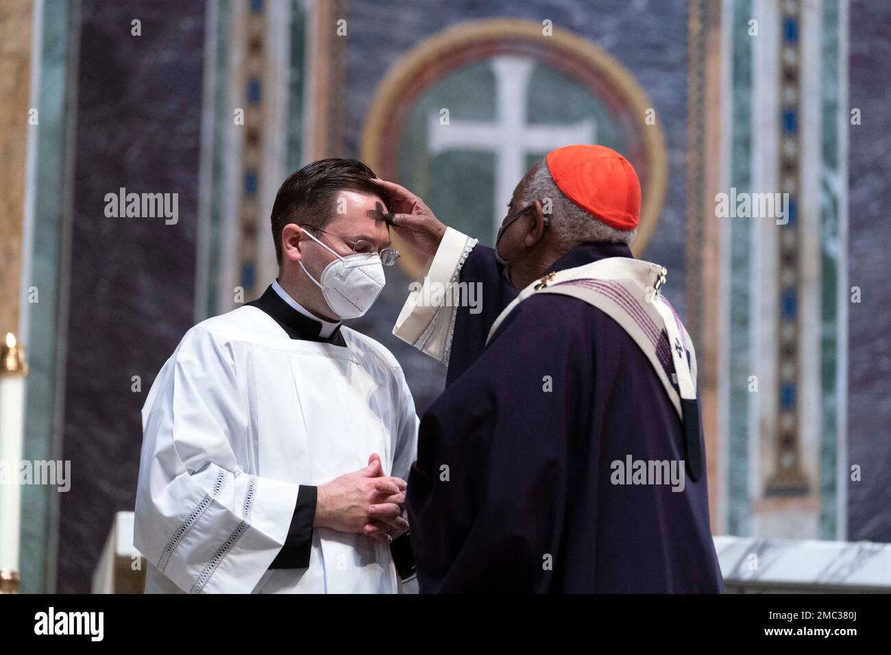 Cardinal Wilton Gregory, Archbishop of Washington places ashes on the  forehead of parishioners duringthe Ash Wednesday mass which marks the  beginning of Lent at Saint Matthew the Apostle Cathedral in Washington,  Wednesday