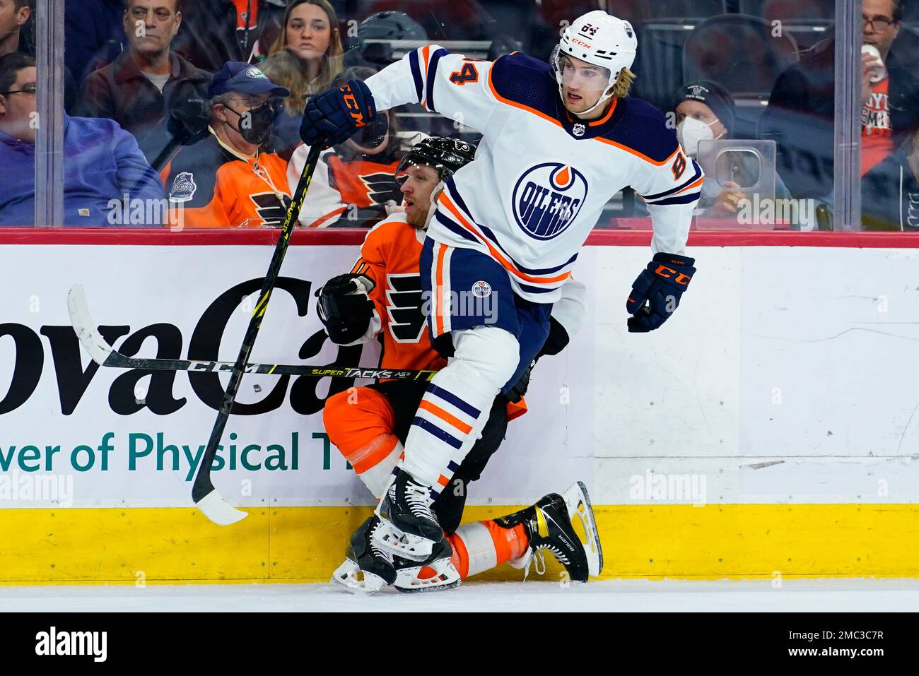 Edmonton Oilers' William Lagesson, right, collides with Philadelphia