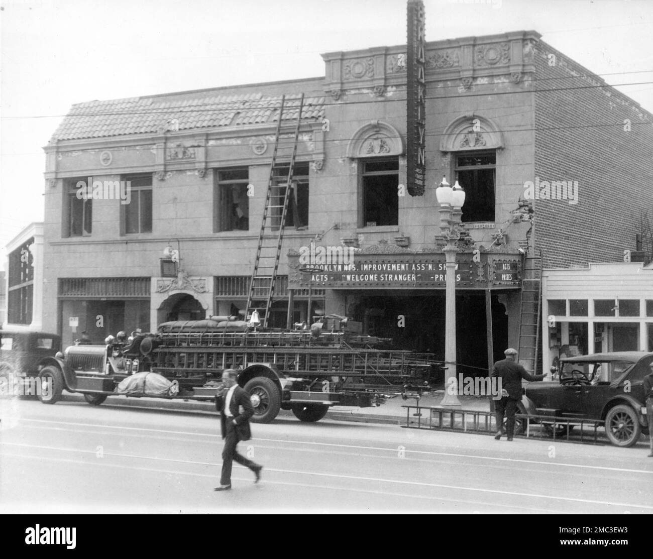 The Brooklyn Movie Theatre in Los Angeles which opened on December 24th 1925 after its criminal destruction / demolition with dynamite soaked in kerosine in June 1926 showing Fire Truck / Engine outside Stock Photo