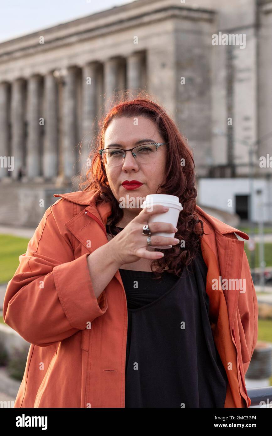 Portrait of an attractive plus-size woman looking at camera while having a Coffee in a University background Stock Photo