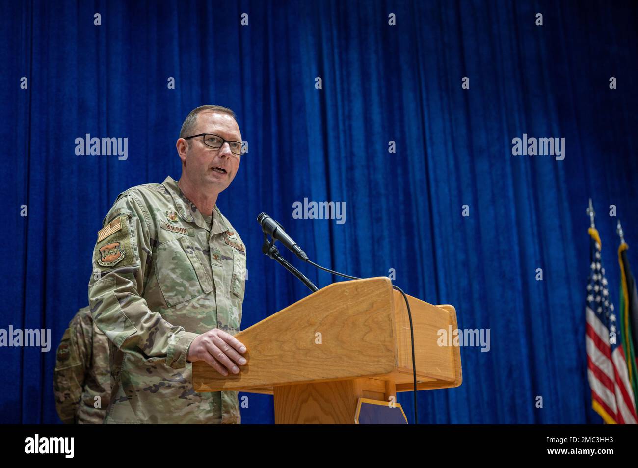 U.S. Air Force Col. Clinton M. Wilson, commander of the 386th Air Expeditionary Wing, gives remarks during an assumption of command ceremony at the base theater at Ali Al Salem Air Base, Kuwait, June 24, 2022. Maj. Cory A. Staudinger, incoming commander, 386th Expeditionary Aircraft Maintenance Squadron succeeded Lt. Col. Dale Ellis, outgoing commander, 386th EAMXS. Stock Photo