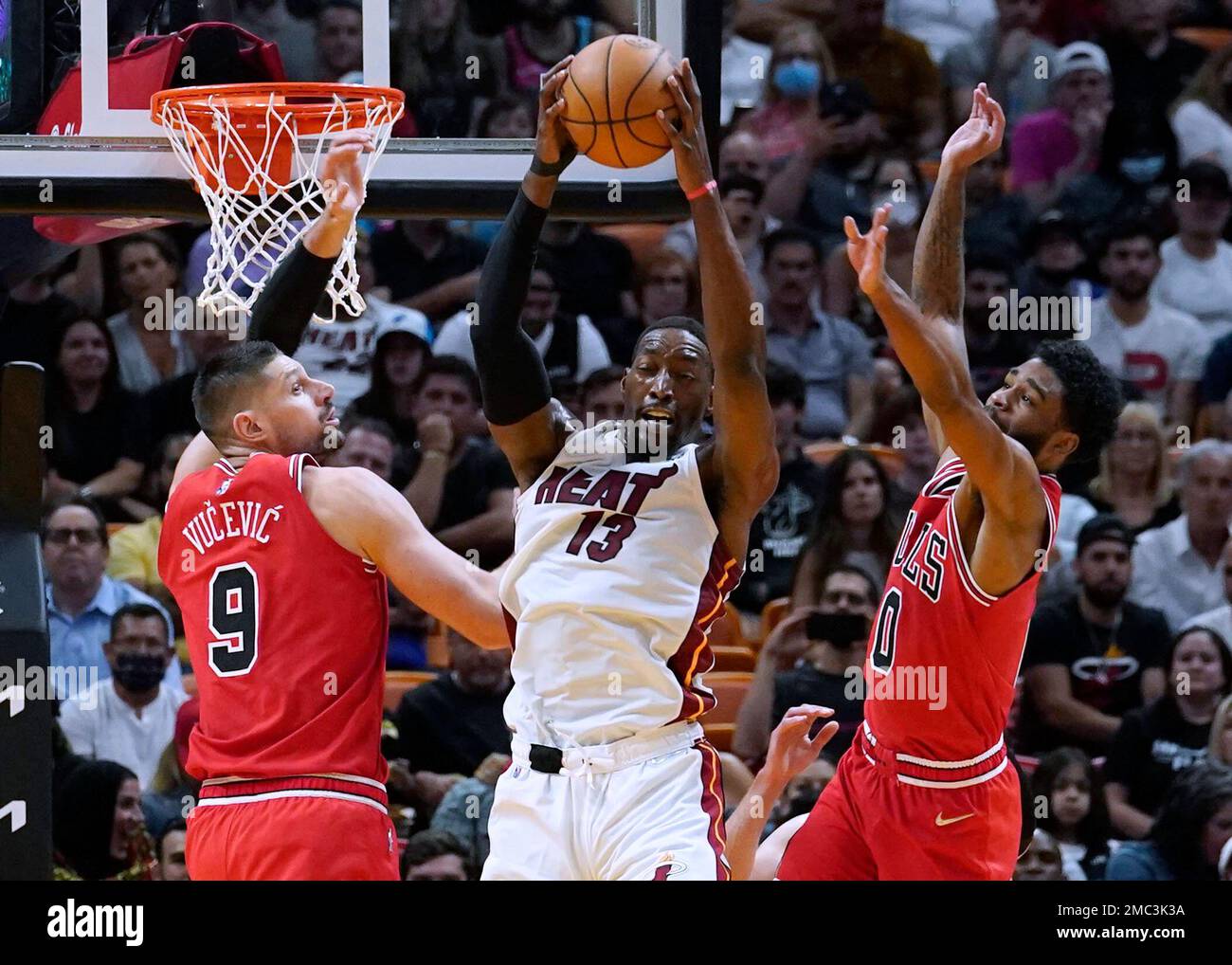 Miami Heat center Bam Adebayo (13) grabs a rebound between Chicago