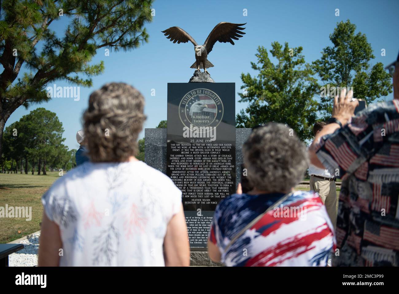 Family members of Airman 1st Class Justin Wood, deceased, take photos of a Khobar Towers