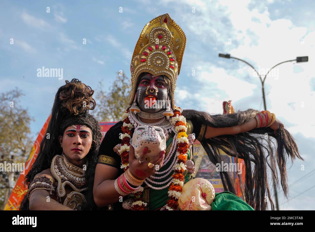 Devotees dressed as Hindu god Shiva and goddess Kali participate ...