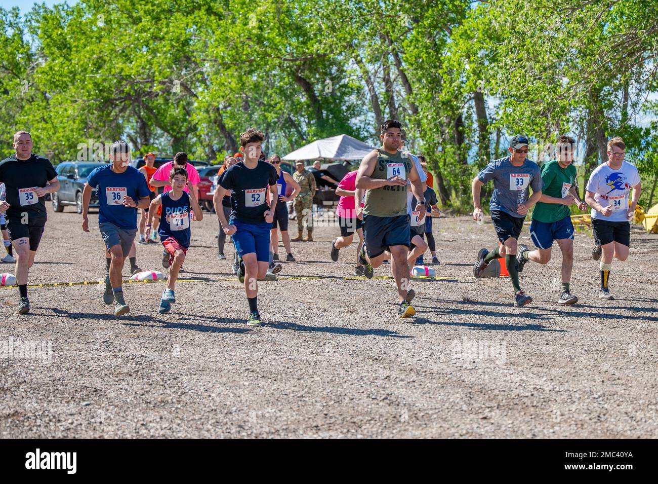 Participants of the Filthy Mudder Mud Run launch from the starting line ...