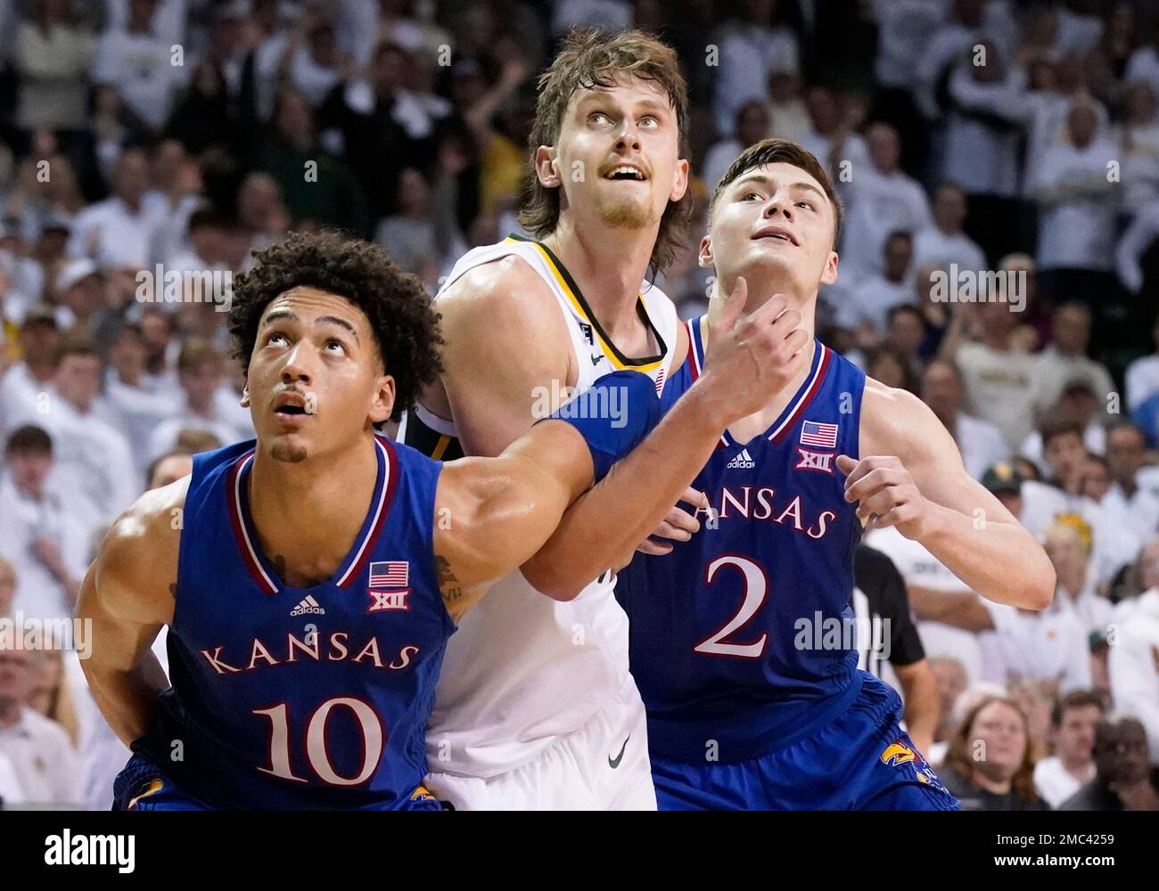 Baylor guard Matthew Mayer, center, is boxed out by Kansas forward