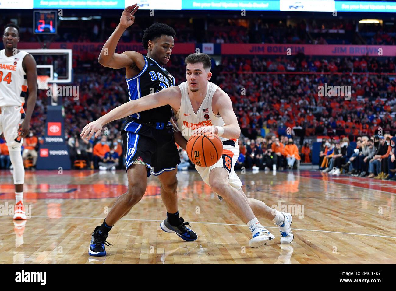 Syracuse guard Joseph Girard III, right, is defended by Duke guard