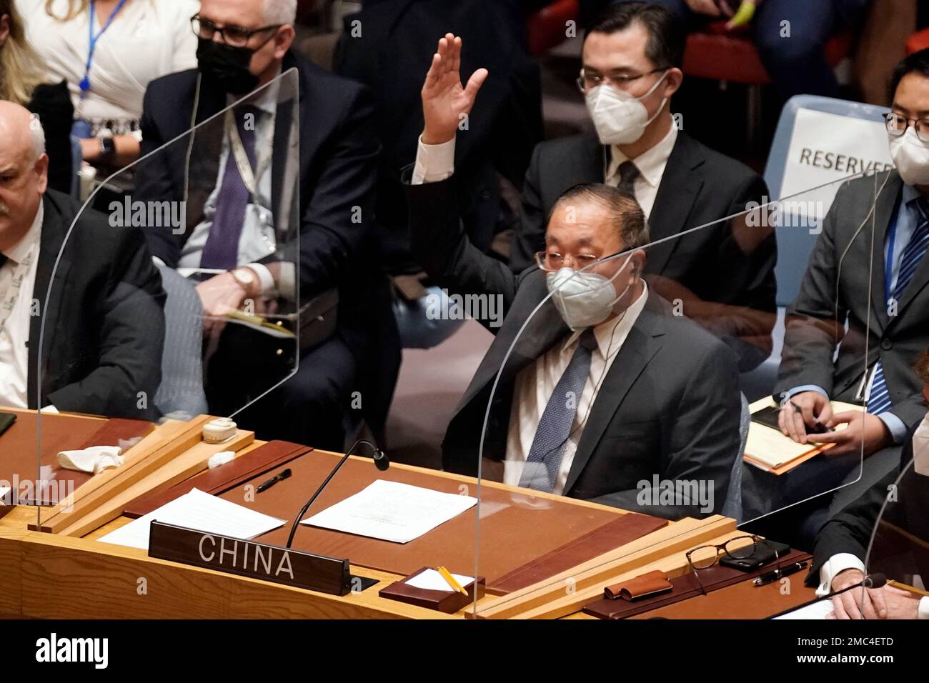 China's UN Ambassador Zhang Jun votes to abstain, in the United Nations Security Council, Friday