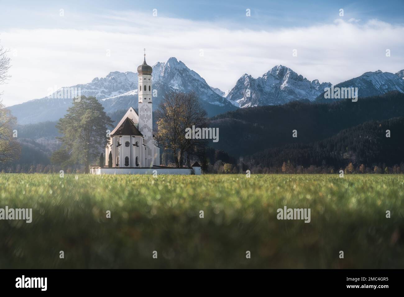 St Coloman Church with Alps Tannheim Mountains on background - Schwangau, Bavaria Stock Photo