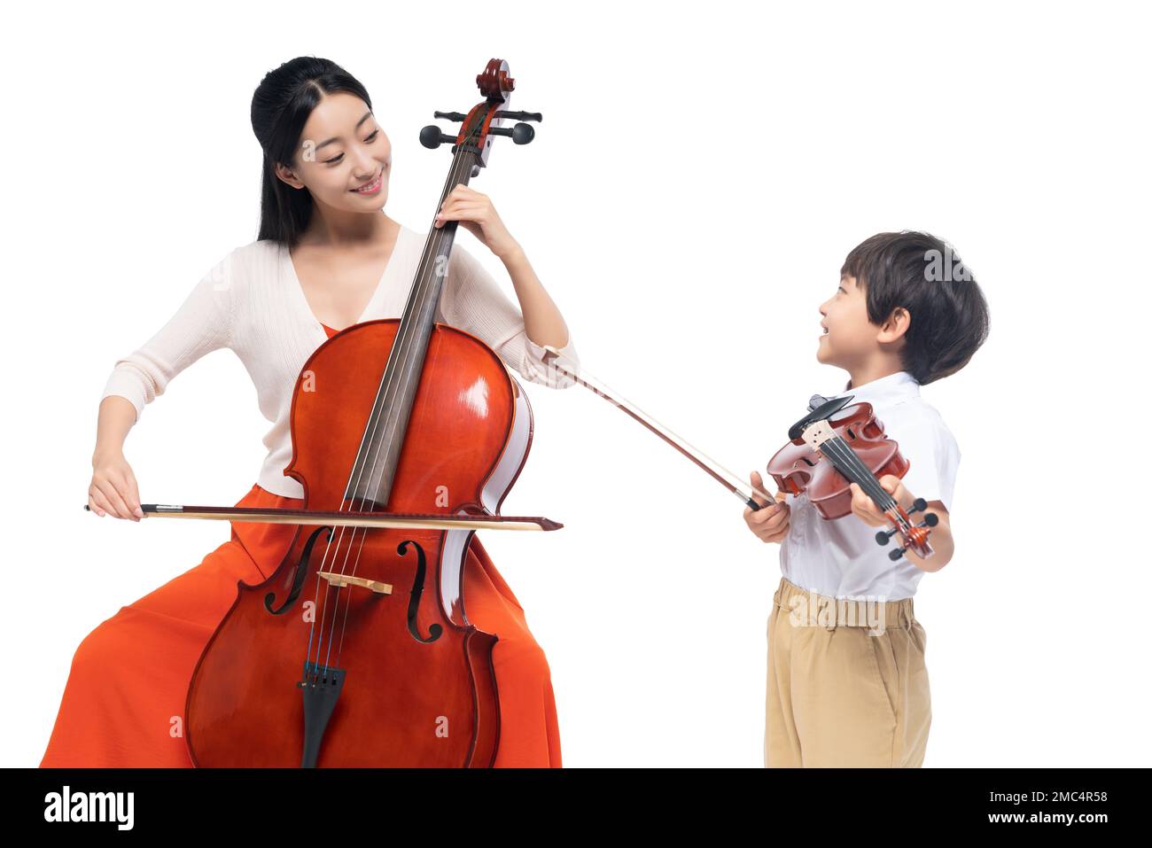 The female teacher guide the boy playing Musical Instruments Stock Photo