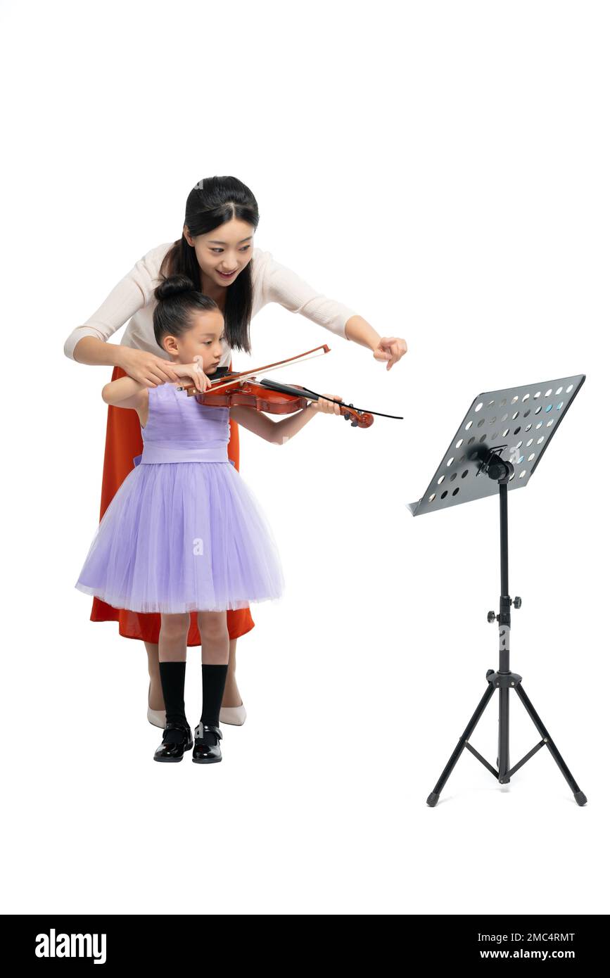 The female teacher guide girl playing Musical Instruments Stock Photo