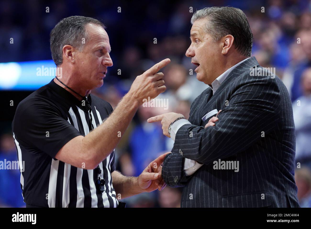Kentucky coach John Calipari, right, and referee Terry Oglesby have a