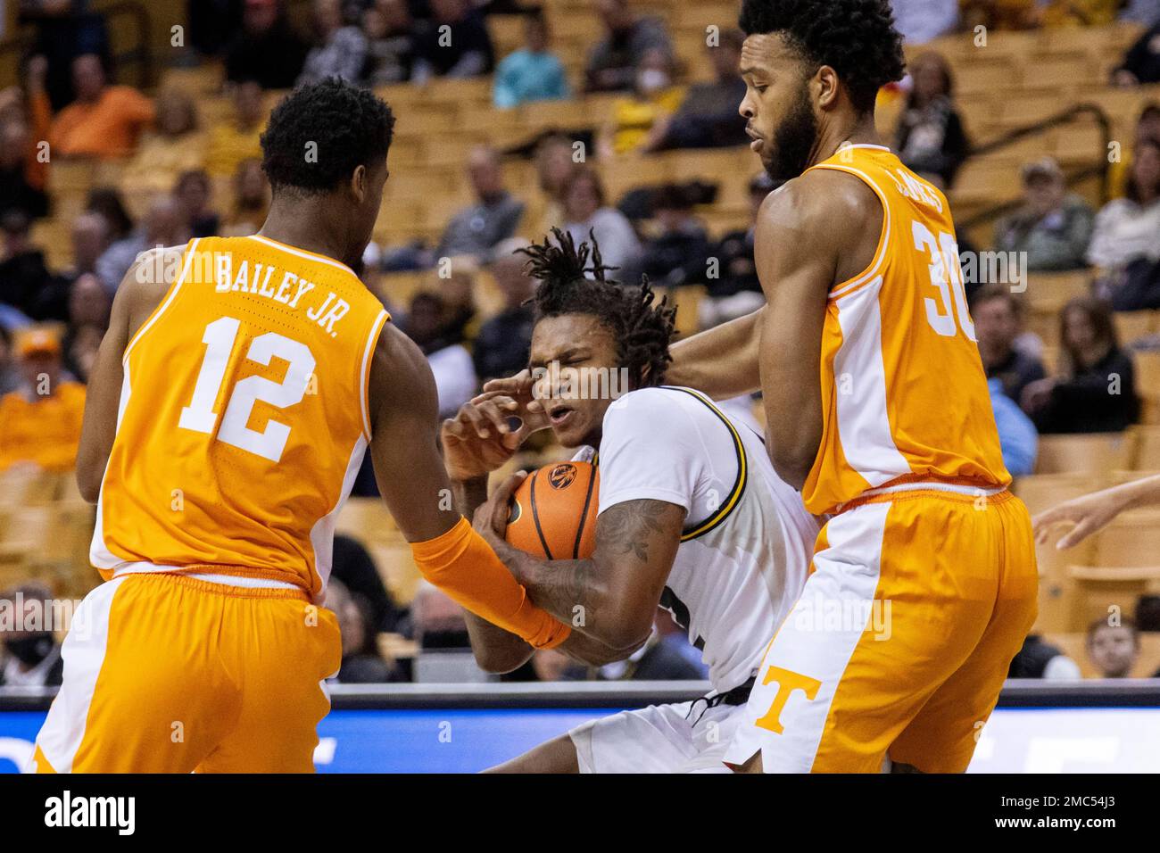 Missouri's DaJuan Gordon, center, pulls the ball away from Tennessee's  Josiah-Jordan James, right, and Victor Bailey Jr. during the first half of  an NCAA college basketball game Tuesday, Feb. 22, 2022, in