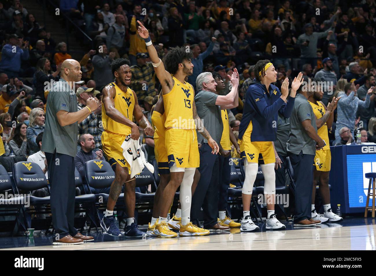 West Virginia players and coaching staff celebrate after a score
