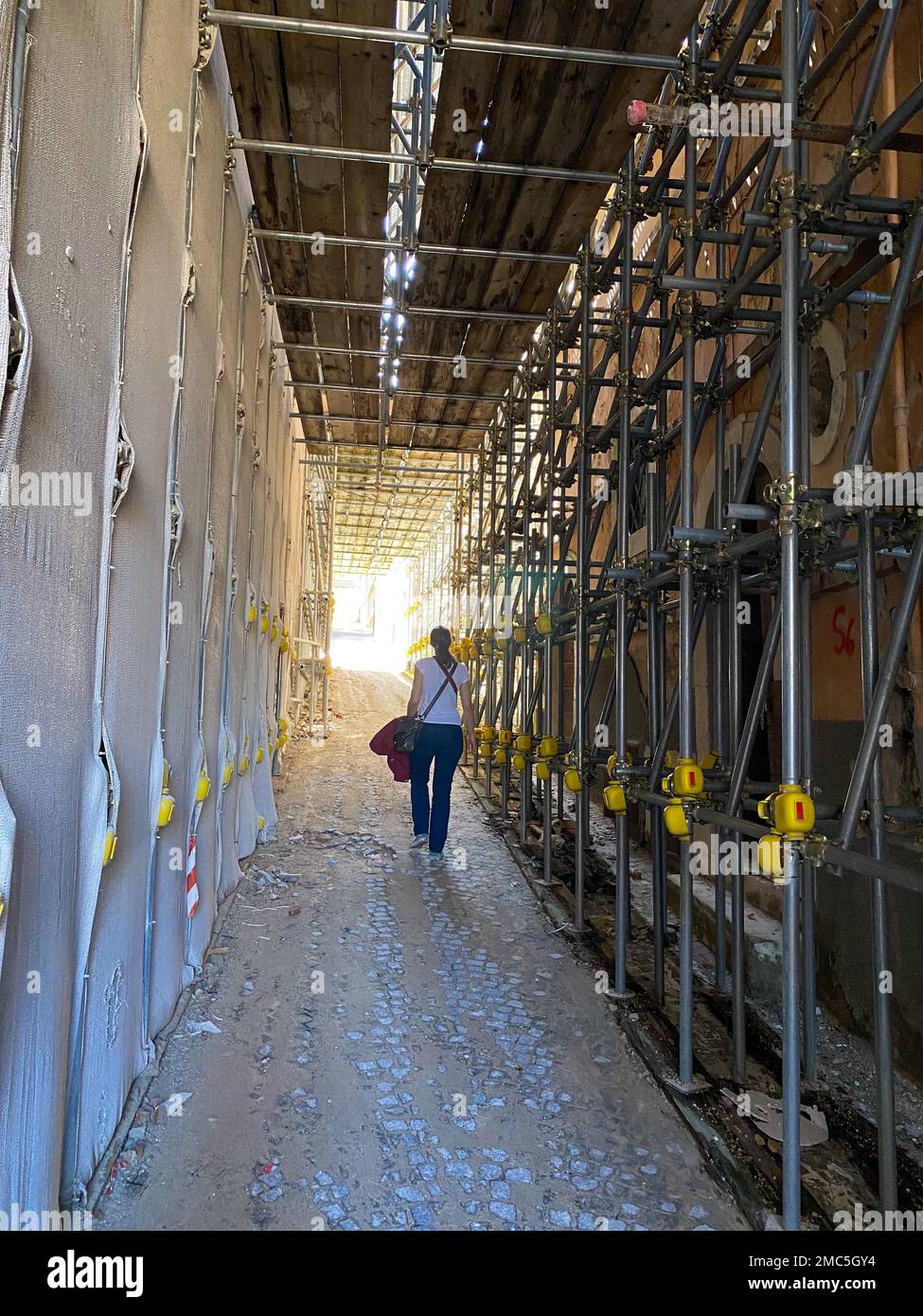 Walking through a scaffolding tunnel in the from earthquake destroyed