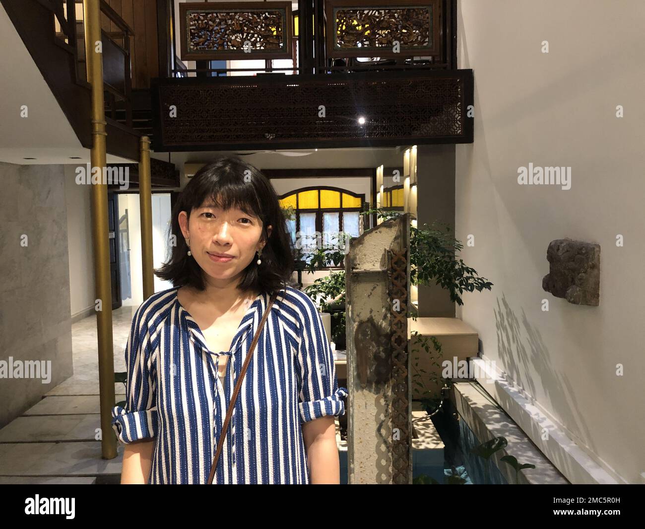 Sammi Liu, co-founder of Beijing and London-based gallery Tabula Rasa, at an exhibition she organised for the artist Li Tao in a traditional Nanyang mansion at the Emerald Hill Conservation Area in the centre of Singapore during Singapore Art Week 2023 Stock Photo
