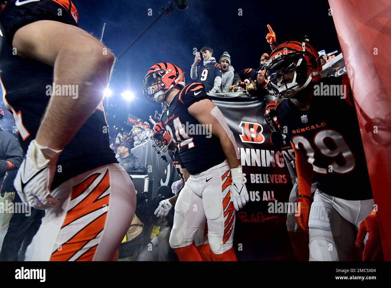 Cincinnati Bengals tight end Mitchell Wilcox (84) and cornerback Cam Taylor- Britt (29) take the field before an NFL wild-card football game against the  Baltimore Ravens on Sunday, Jan. 15, 2023, in Cincinnati. (