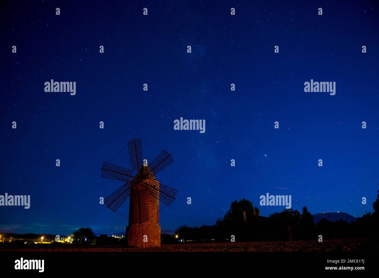 Traditional majorcan windmill on a field by night Stock Photo