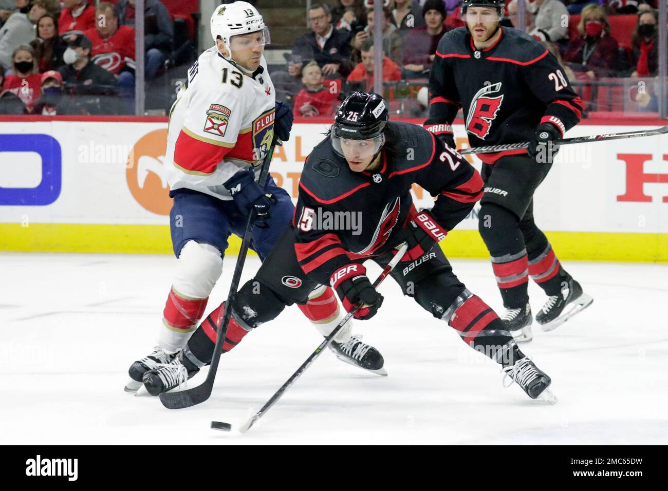Carolina Hurricanes' Ethan Bear (25) skates with the puck during the first  period of an NHL