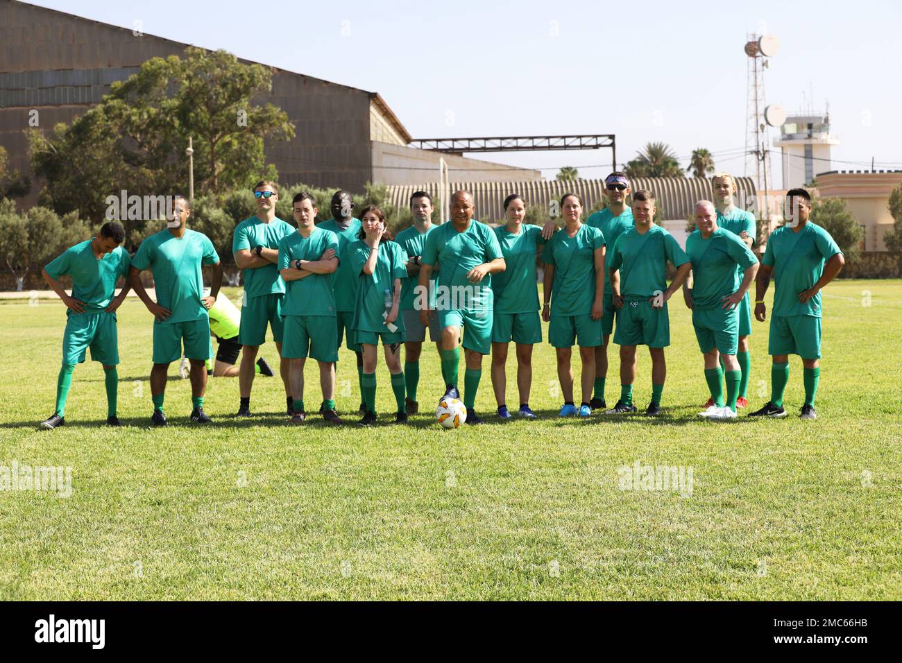 Players clad in green jerseys, one of the four teams participating in a camaraderie-building multinational soccer game during African Lion 22, pose for a group photo at Southern Zone Headquarters, Agadir, Morocco June 25, 2022. African Lion 22 is U.S. Africa Command's largest, premier, joint, annual exercise hosted by Morocco, Ghana, Senegal and Tunisia, June 6 - 30. More than 7,500 participants from 28 nations and NATO train together with a focus on enhancing readiness for U.S. and partner nation forces. AL22 is a joint all-domain, multi-component, and multinational exercise, employing a full Stock Photo
